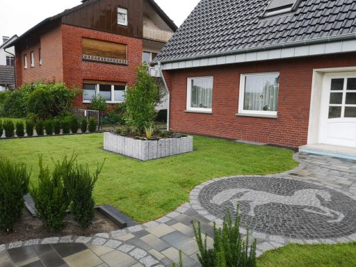 Hauseingang in einem Vorgarten mit Motivpflasterung
